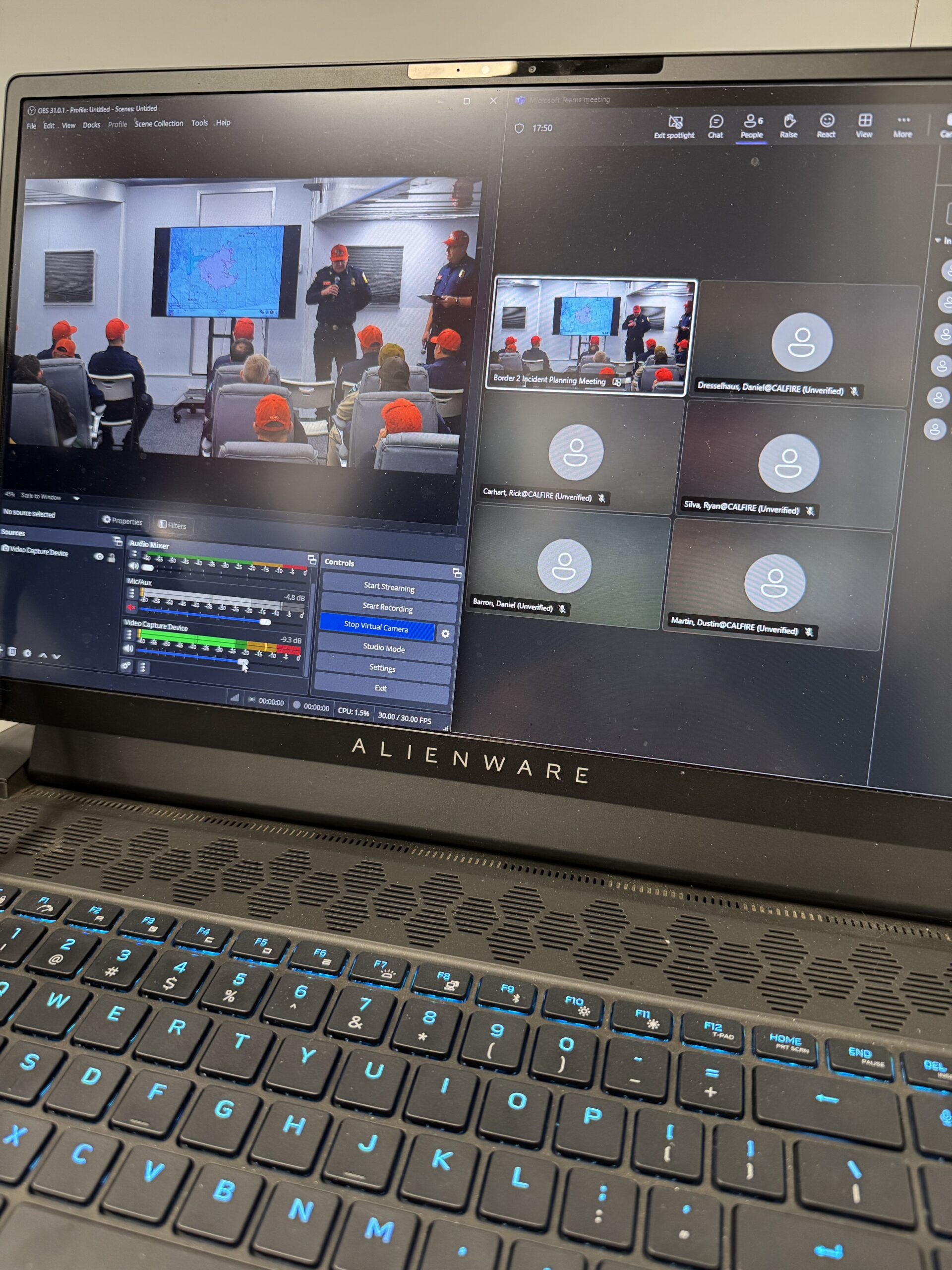 A laptop running OBS encoding an in-room incident planning briefing into a live Microsoft Teams session with remote participants.